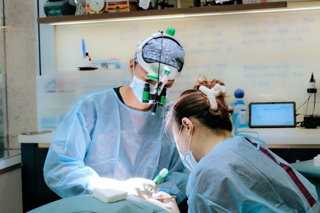 A Doctor and Technician extracting grafts during a hair transplant done in a hair restoration clinic in Singapore