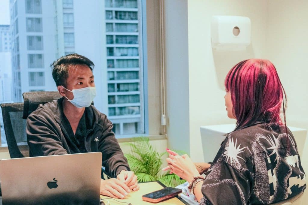 A doctor doing a consultation on a patient with Female Pattern Hair Loss in Singapore