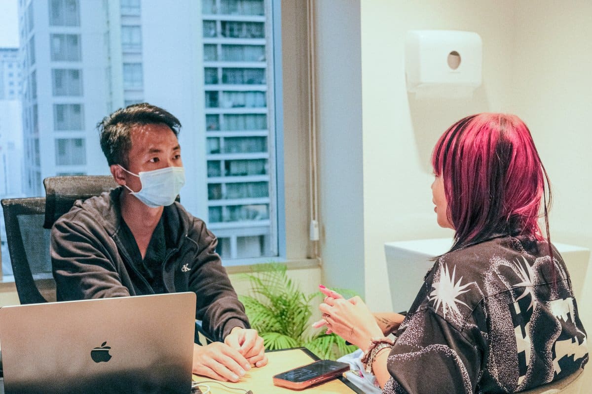 A doctor doing a consultation on a patient with Female Pattern Hair Loss in Singapore